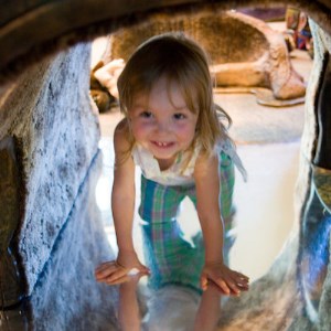 Tiny Tyke Time Registration Girl crawling through cave