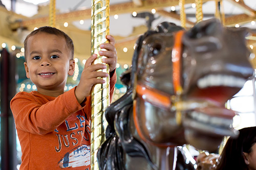 kid on carousel